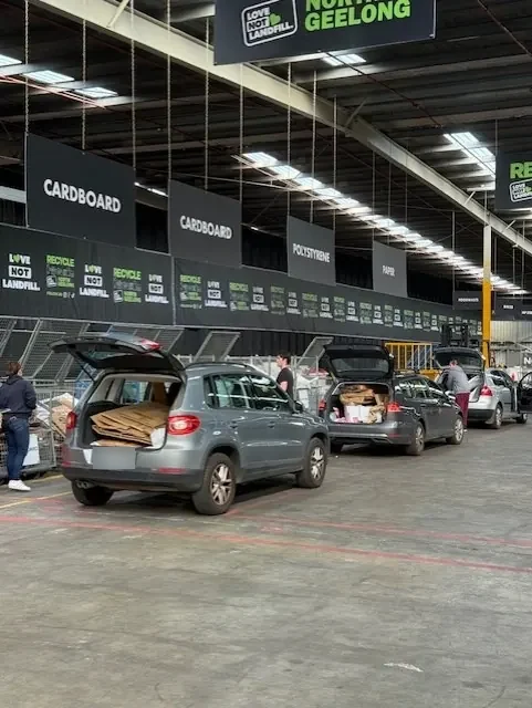 A customer unloading boxes from a car at the cardboard bays